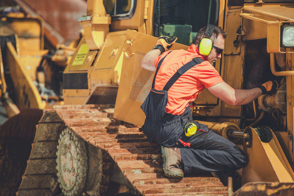 Heavy equipment mechanic works on a bulldozer. These mechanic jobs are some of the best paying jobs in the skilled trades